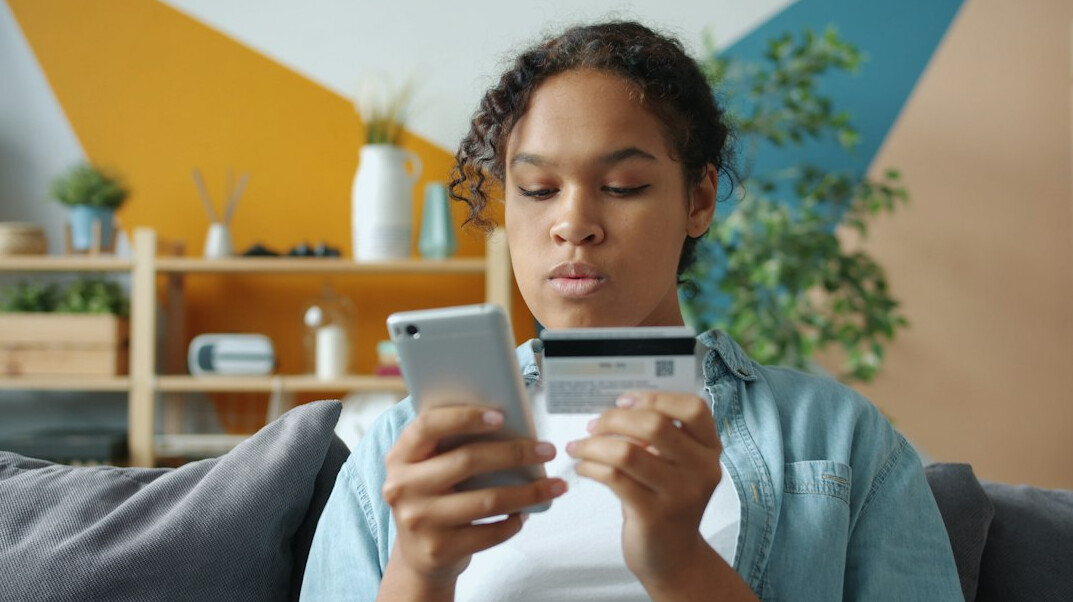 woman checking bank app on phone