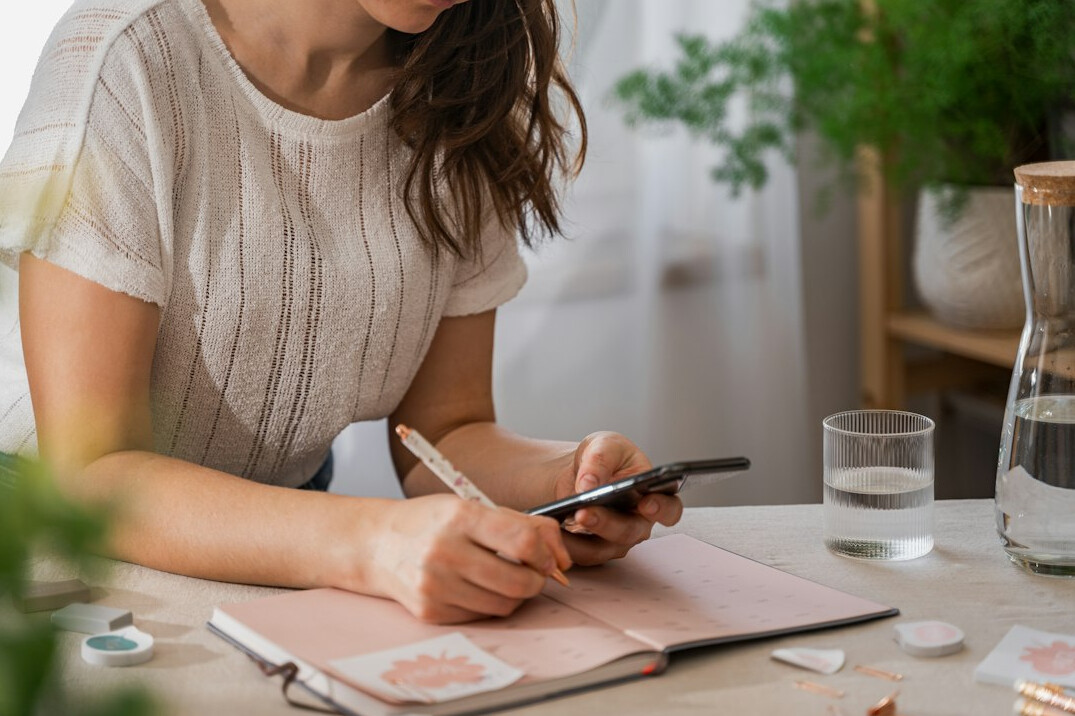 person writing budget plan