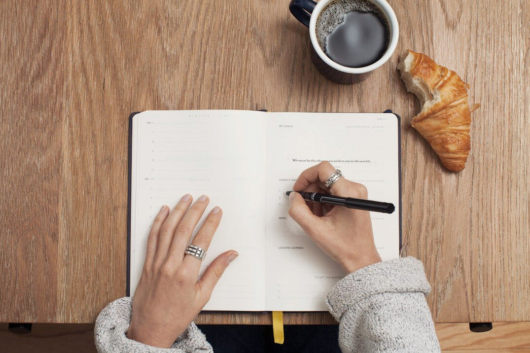 person writing budget plan